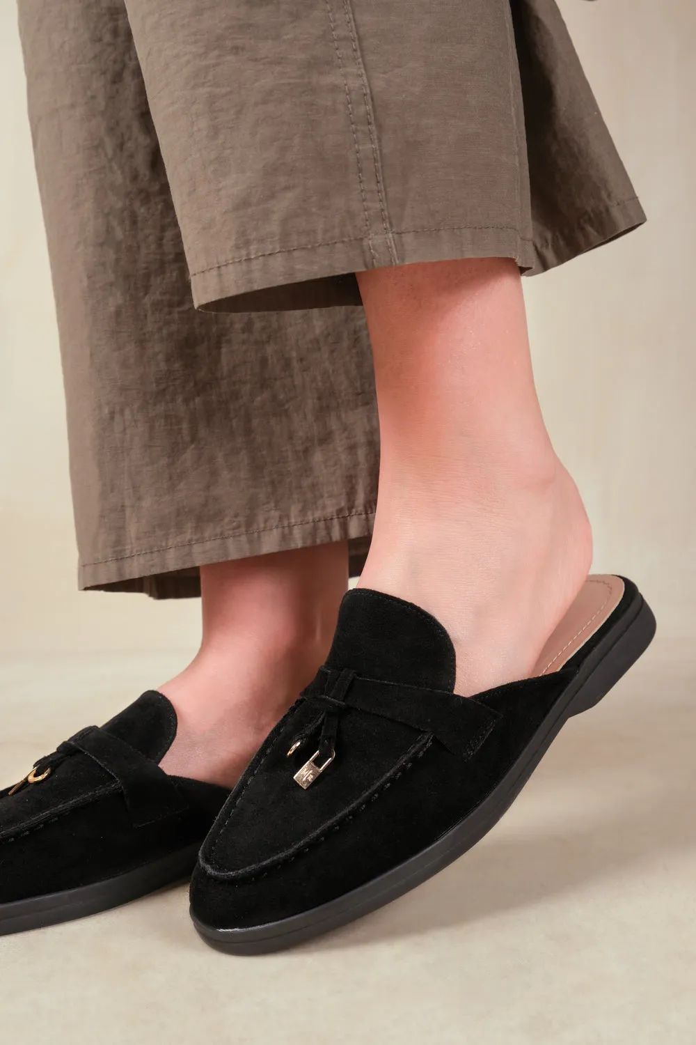 TWILIGHT FLAT SLIP ON LOAFER WITH TASSEL DETAIL IN BLACK SUEDE